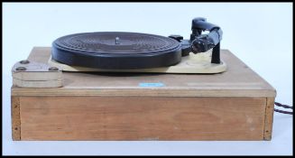 A vintage early 20th century Garrard Model T&M Mk II record deck set to a wooden base, the turntable