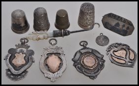 A selection of silver and metal items to include four hallmarked silver sporting medals/ badges