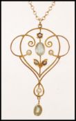 An early 20th century 9ct gold Edwardian seed pearl and aquamarine necklace and pendant. The pendant