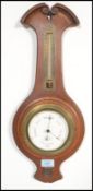 A 20th Century wooden case wall barometer / thermometer by Negretti & Zambra having a scrolled