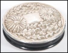 A vintage silver embossed double panel hand mirror having decoration of flowers and leaves. Silver