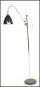A contemporary floor standing standard / reading /spot lamp. The lamp on a chrome circular base with