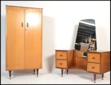A mid 20th Century vintage Austinsuite bedroom suite in teak comprising of a dressing table with a