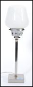 A vintage retro 20th century Art Deco influence table lamp raised on chrome square base with tall