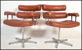 A pair of retro 20th century salon / barbers. Having a red button back vinyl upholstery, reclining