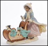 A Lladro figural group 'Sleigh Ride', No. 5037 boy and girl in sleigh pulled by a dog with leather