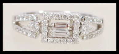 A Mappin and Webb 18ct white gold and diamond art deco style ring set with a central rectangular