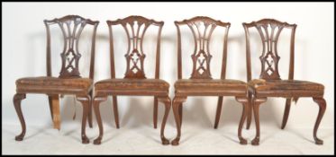 A set of four 19th Century Chippendale revival large mahogany dining chairs, each raised on cabriole
