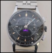 A vintage 1960's chronograph Sekonda 19 Jewels Tachymetre watch having a black enamelled face with