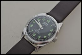 A vintage gentleman`s stainless steel HMT Jawan military wristwatch with black dial, Arabic numerals