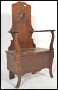 A 1920's oak Jacobean revival JAS Shoolbred of London oak hall settle chair / bench. The seat with