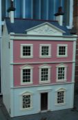 A vintage 20th century good sized dolls house having large hinged door with multiple rooms, stairway