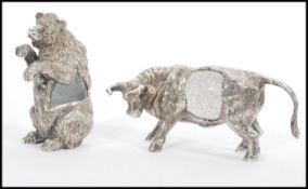 Two signed silver plated ornaments to include a highland cow having a glass control bubble centre