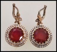 A pair of stamped 925 silver renaissance style earrings set with round faceted rubilite stones and
