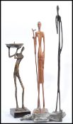 A group of three vintage 20th century bronze African figures / statues to include a candlestick