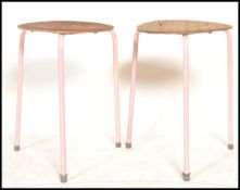 A pair dot stool chairs in the manner of Arne Jacobsen for Fritz Hansen. Each on tubular frames with