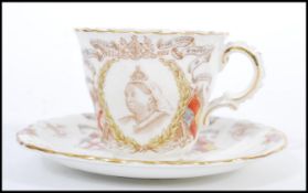 A 19th Century Victorian cupboard display commemorative cup and saucer for the diamond jubilee