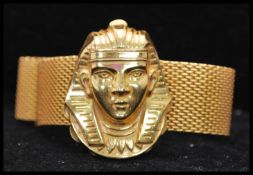 A 1970s signed Miriam Haskell Egyptian revival mesh wrap bracelet having a large pharaohs head