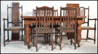 A 19th century Victorian large oak extendable winder dining table raised on turned supports with two