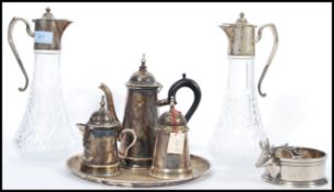 A group of good quality silver plate to include a pair of silver plated and cut glass claret jug,