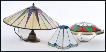 A group of vintage Tiffany style stained glass lamps and shades to include on lamp with leaded glass