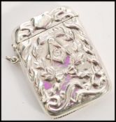 A stamped sterling silver vesta case with embossed masonic decoration featuring a G surrounded by