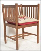 A 20th century Arts & Crafts  / Shaker revival teak wood armchair raised on squared legs with