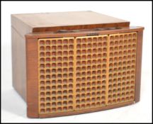 A vintage 20th Century table top radiogram in a walnut case, fitted Garrard four speed record deck