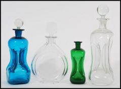 A group of early 20th Century kluk kluk decanters a large white glass example with a ball finial