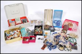 A large collection of costume jewellery to include chains and necklace pendants, brooches, pearls,