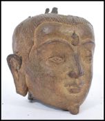 A 19th century Chinese bronze Buddha head having detailed features. 15cm high.