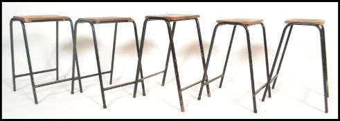A set of 4 retro 20th century Industrial lab - laboratory stools raised on tubular black metal