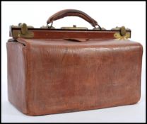A vintage early 20th century leather Gladstone type doctors bag having brass locks and escutcheon