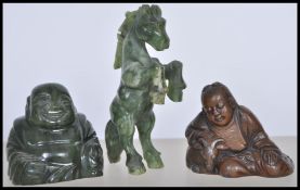 A group of three Chinese figures to include a jade figurine of a horse in rearing position, a carved