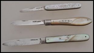 A group of three silver hallmarked and mother of pearl handled fruit pen knives. One hallmarked