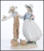 A Lladro porcelain figurine of a lady and scarecrow. Model 5835. Printed marks to base. 27cm high.