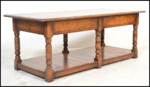 A 20th Century oak peg jointed coffee table in a Jacobean revival style, rectangular top raised on