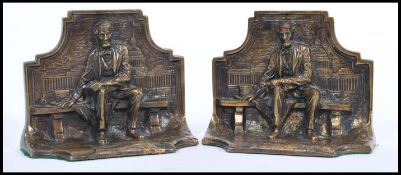 A pair of early 20th century bronze bookends in the form of Abraham Lincoln seated on bench. Made in