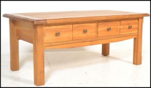 A contemporary chunky oak ' furniture land ' style coffee table of rectangular form with squared