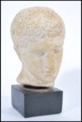 A vintage 20th Century classical style plaster head bust study of David raised on an ebonised