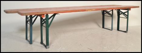 A pair of mid 20th Century Industrial factory work benches. Each of panelled wood with folding metal