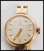 A hallmarked 9ct gold ladies Omega cocktail watch set to a 9ct gold watch bracelet. Champagne dial