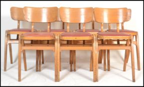 A set of seven vintage retro 20th century beech stacking chairs in the manner of Ben chairs raised