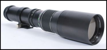 A 35MM Access SQ fixed focus telephoto lens No. 39361 with a screw attachment for pentax in a fitted