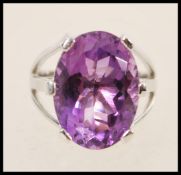 A stamped 925 silver ring prong set with a large oval amythest stone. Weight approx 9.1g. Size Q.