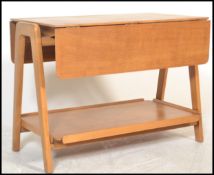 A mid 20th century retro teak two tier  buffet trolley / side table raised of angular form, being