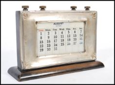 An early 20th century silver hallmarked perpetual desk calendar by W J Myatt & Co mounted on
