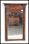 A late Victorian mahogany pier mirror, having decorative turned columns flanking the rectangular