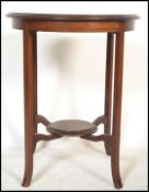 An Edwardian mahogany inlaid centre - occasional table being raised on slender, shaped legs with