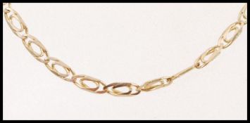 A 9ct gold decorative flat linked chain necklace with a lobster clasp. Weight 7.7g.